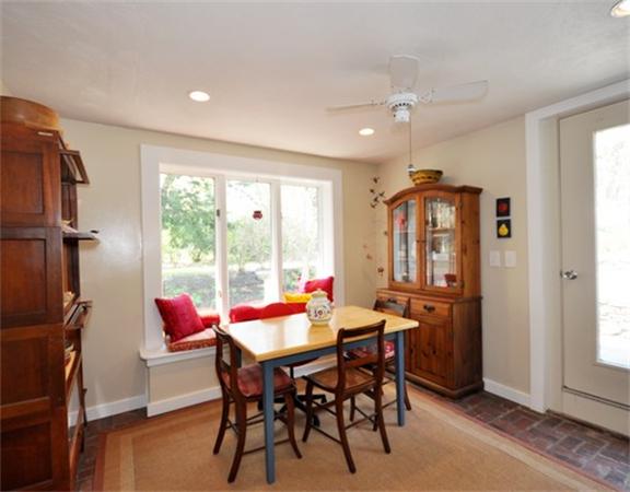 598 Lexington Road Concord, MA 01742 - Photo 10 of 15 a view of a dining room and livingroom with furniture wooden floor a chandelier