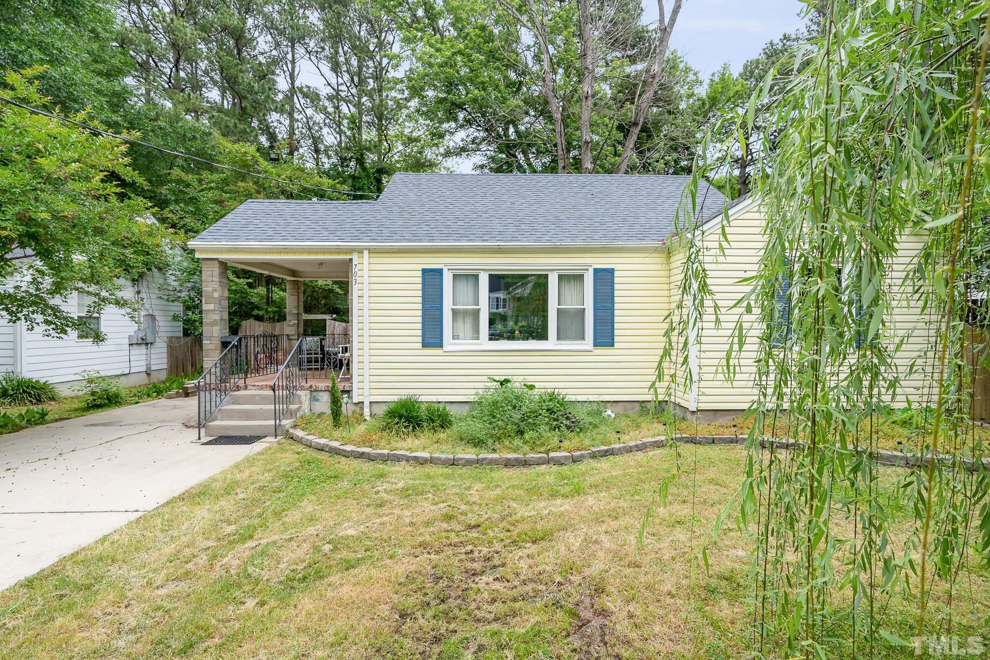 703 Van Buren Road Raleigh, NC 27604 - Photo 1 of 16 a front view of a house with garden
