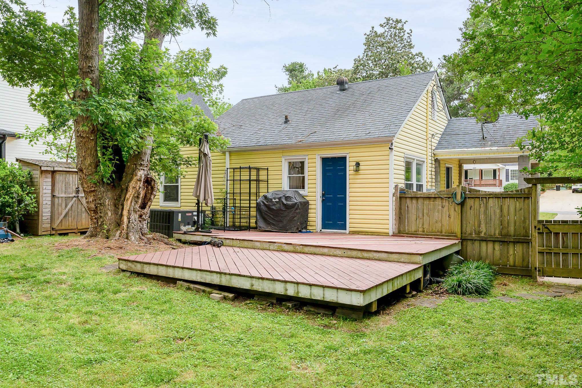 703 Van Buren Road Raleigh, NC 27604 - Photo 15 of 16 a view of a house with a backyard and a patio