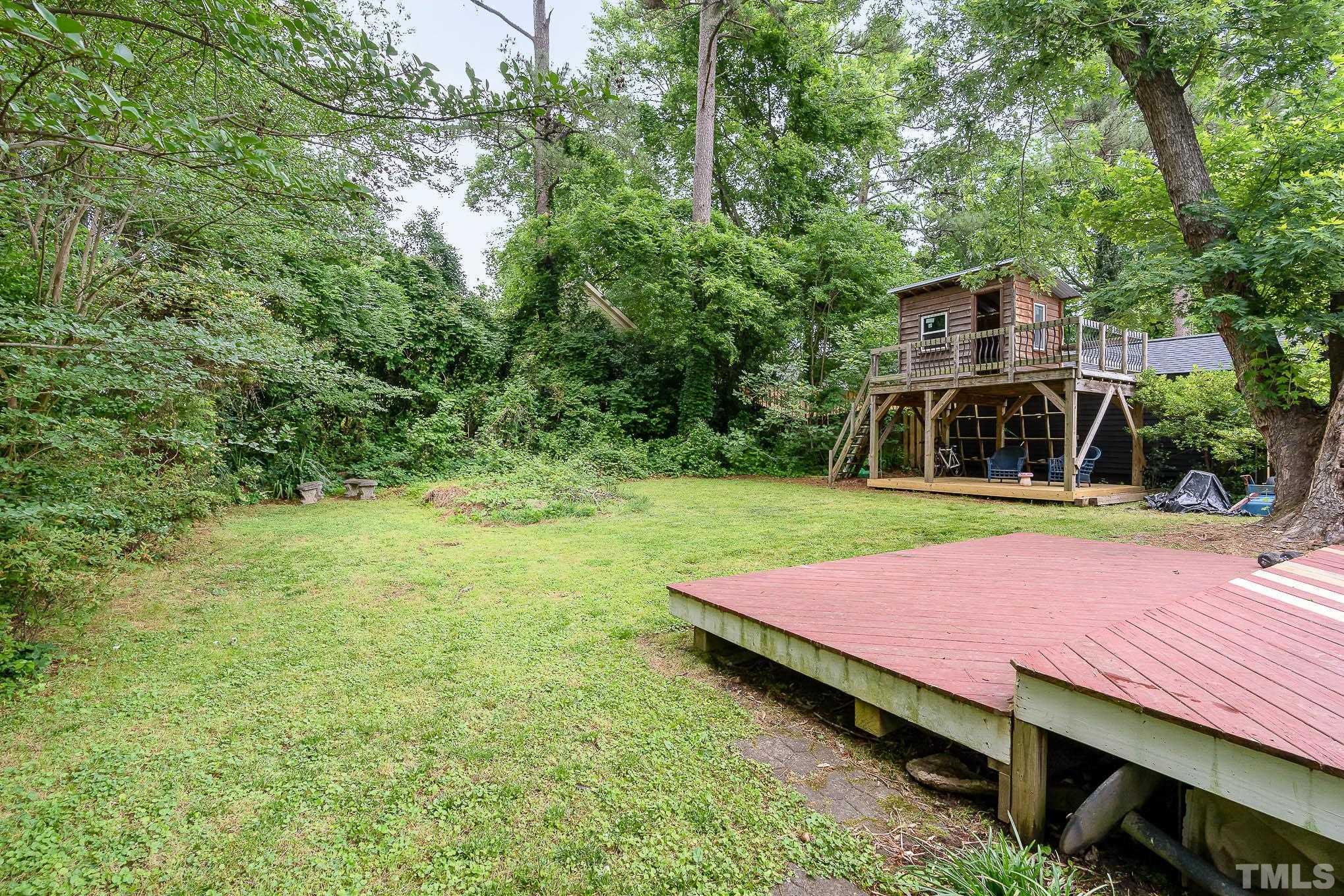 703 Van Buren Road Raleigh, NC 27604 - Photo 16 of 16 a backyard of a house with yard and outdoor seating