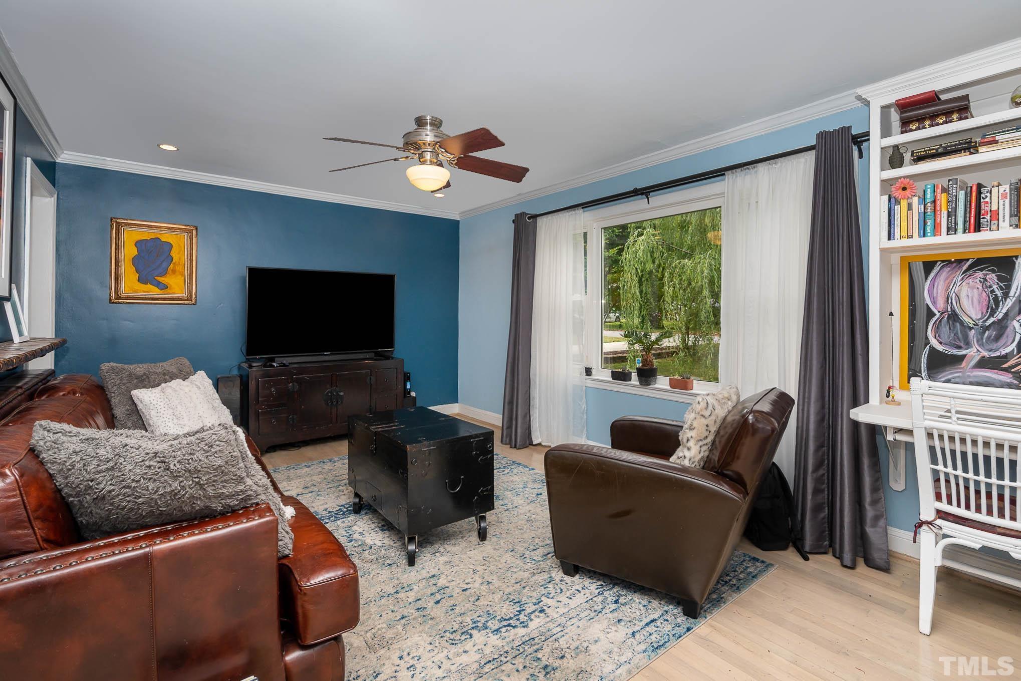 703 Van Buren Road Raleigh, NC 27604 - Photo 3 of 16 a living room with furniture and a flat screen tv