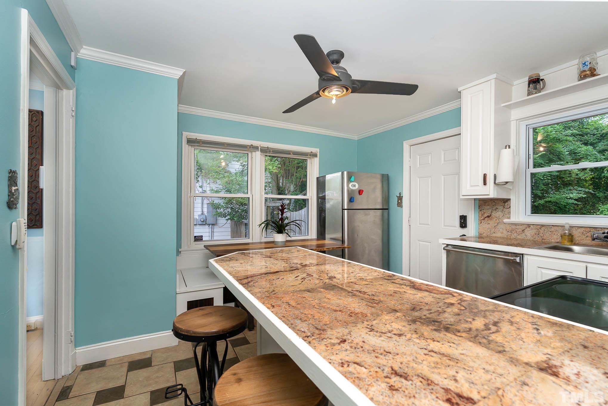 703 Van Buren Road Raleigh, NC 27604 - Photo 8 of 16 a kitchen with stainless steel appliances kitchen island a refrigerator sink and wooden floor