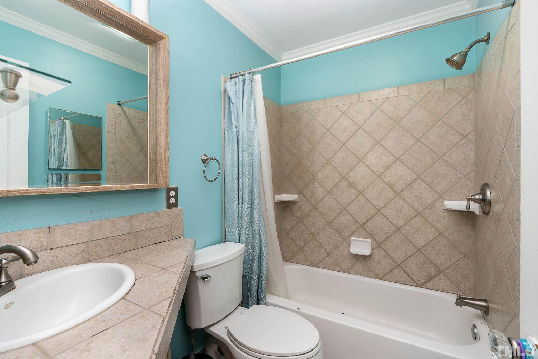 703 Van Buren Road Raleigh, NC 27604 - Photo 9 of 16 a bathroom with a sink toilet and shower