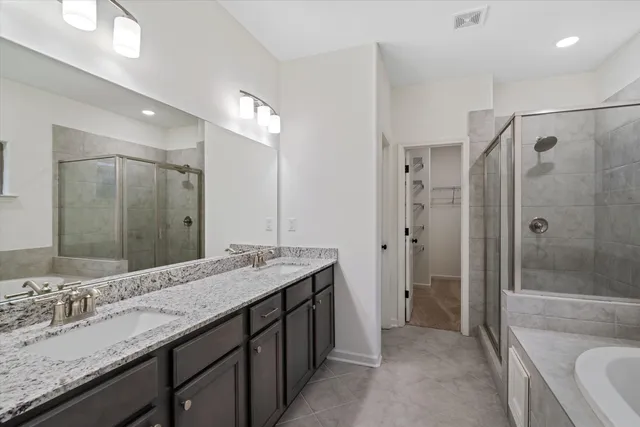 a bathroom with a granite countertop sink mirror and shower