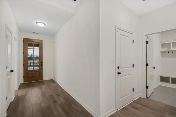a view of a hallway with wooden floor