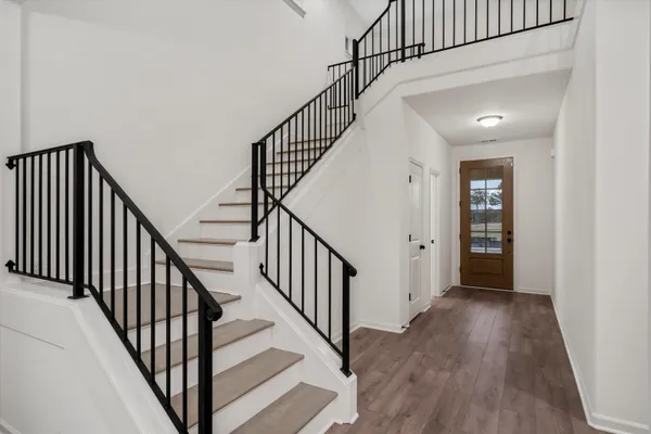 a view of staircase with wooden floor and stairs