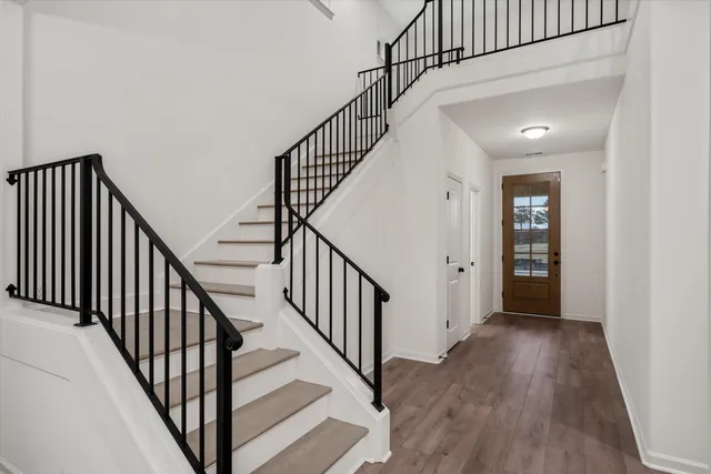 a view of staircase with wooden floor and stairs
