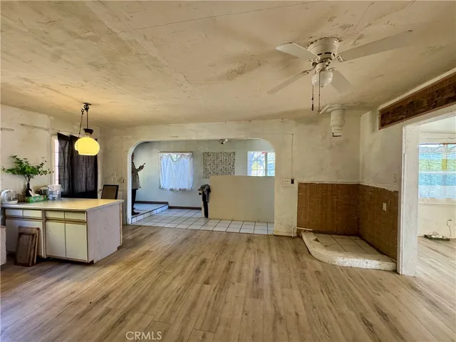 a view of a room with wooden floor and windows