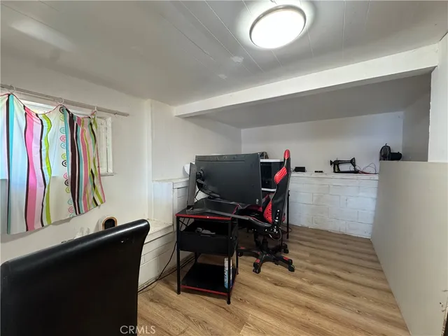 a view of a workspace with furniture and gym equipment