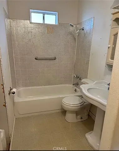 a bathroom with a toilet a sink and a shower