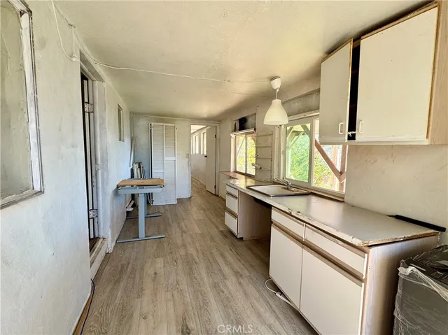 a kitchen with sink cabinets and wooden floor