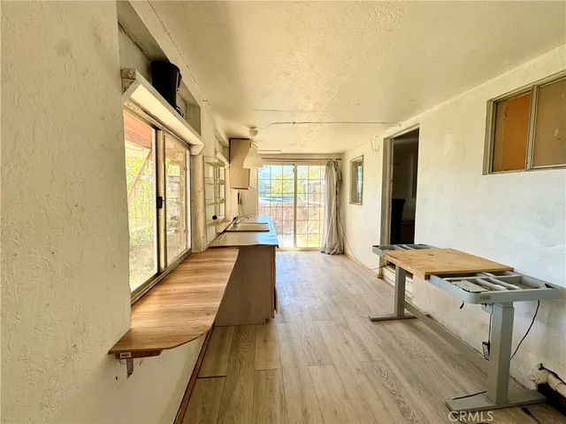 a view of a bedroom with furniture and windows