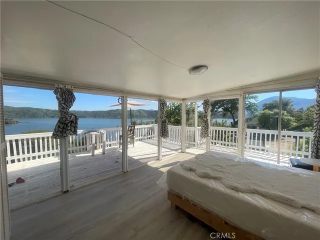 a view of a porch with wooden floor and outdoor space