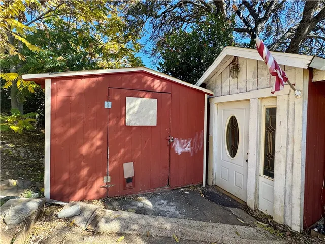 a view of a small house with a tree park