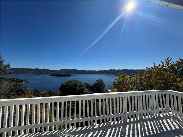 a view of a roof deck with wooden floor and fence