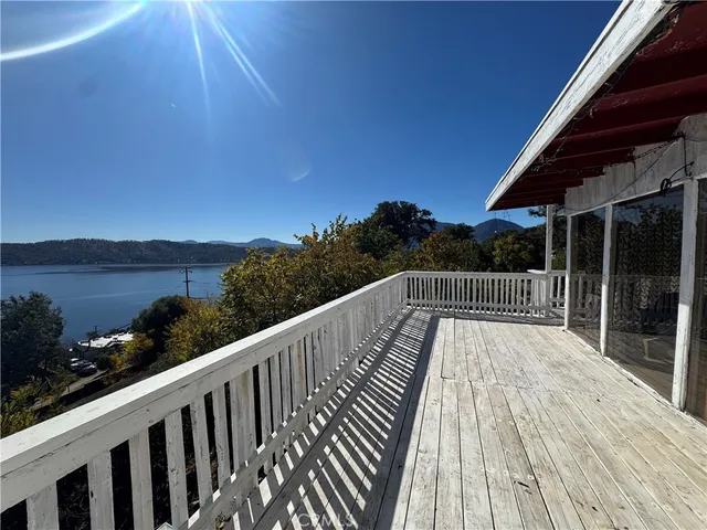 a balcony with wooden floor and city view