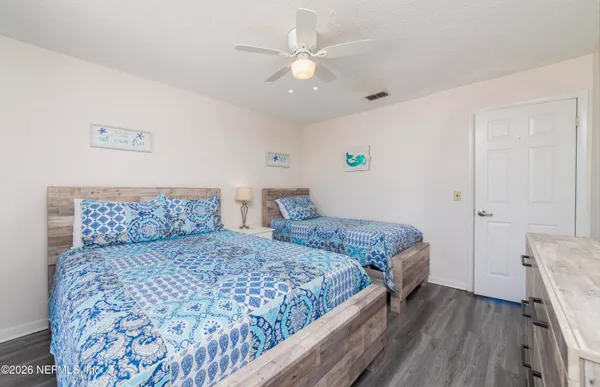 a bedroom with a large bed and a chandelier