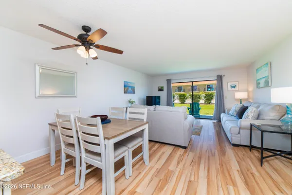 a view of a dining room with furniture window and wooden floor