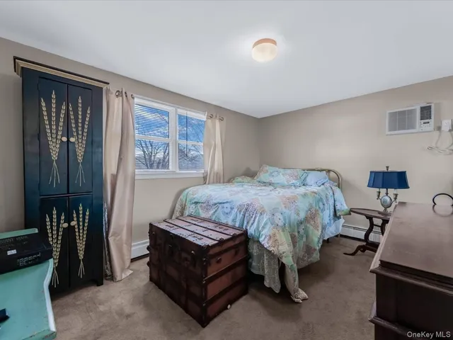 a bedroom with a bed table and a window