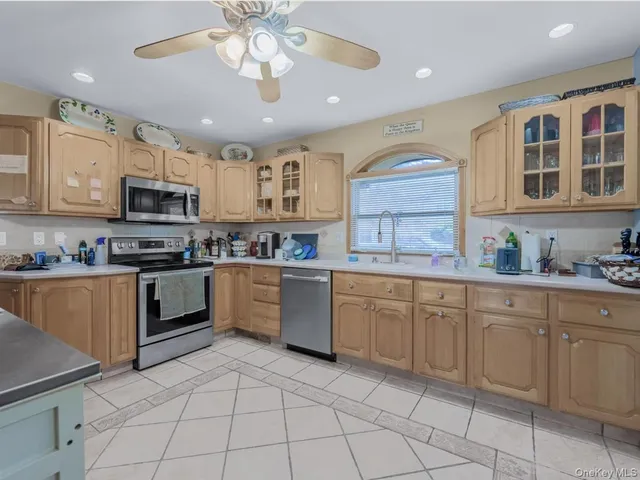 a kitchen with stainless steel appliances granite countertop a stove sink and cabinets