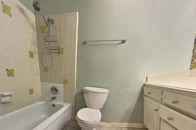 a bathroom with a toilet sink and shower