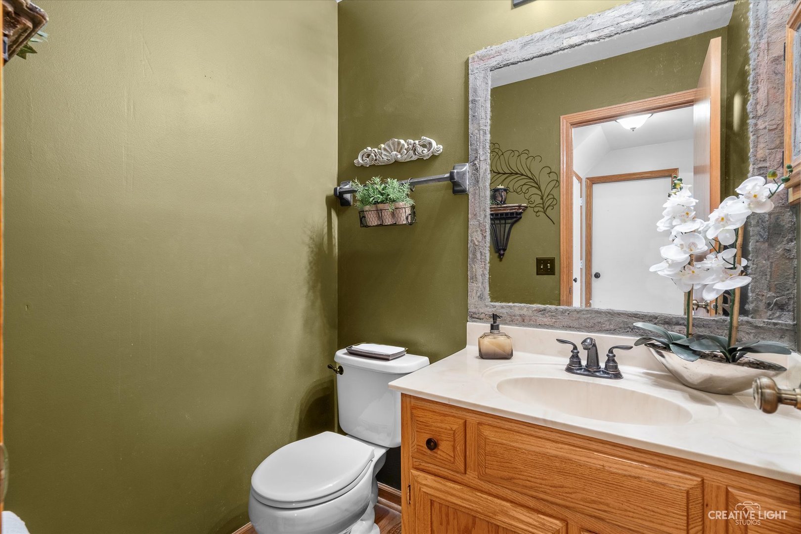 2834 Miller Road Geneva, IL 60134 - Photo 5 of 23 a bathroom with a granite countertop toilet sink and mirror
