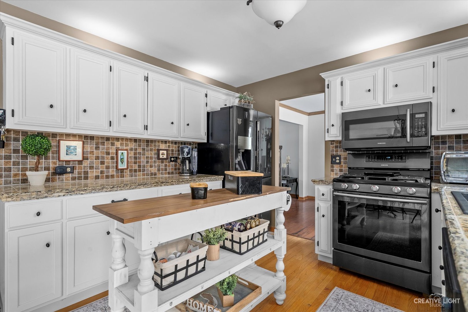 2834 Miller Road Geneva, IL 60134 - Photo 8 of 23 a kitchen with stainless steel appliances granite countertop a stove a sink and a microwave
