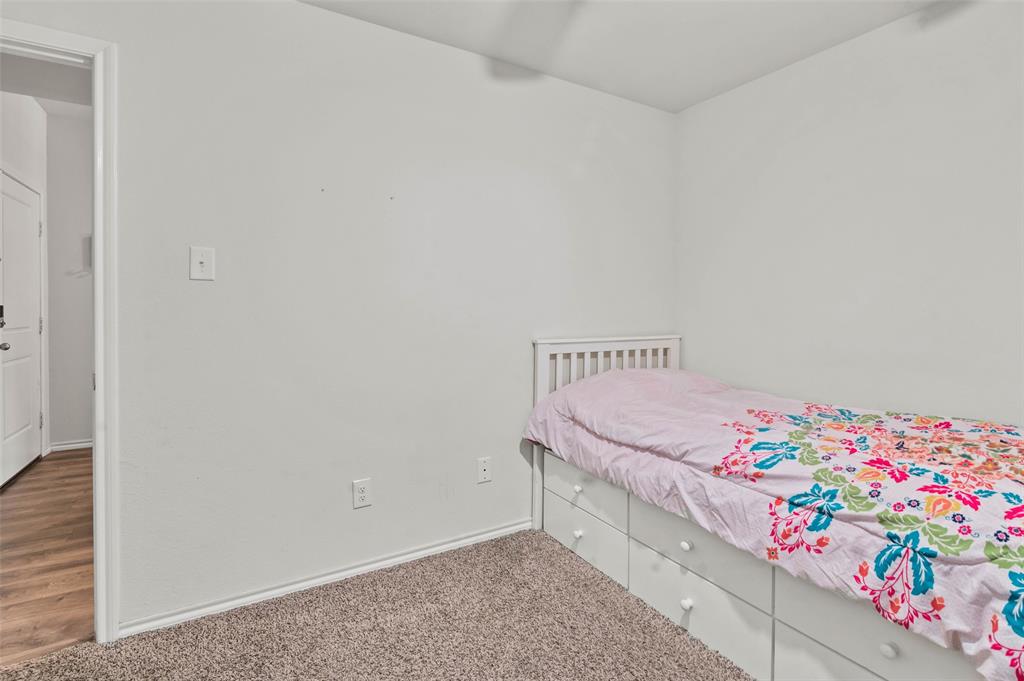 409 Wilson Way Denton, TX 76207 - Photo 21 of 33 Carpeted bedroom with neutral wall paint and white trim