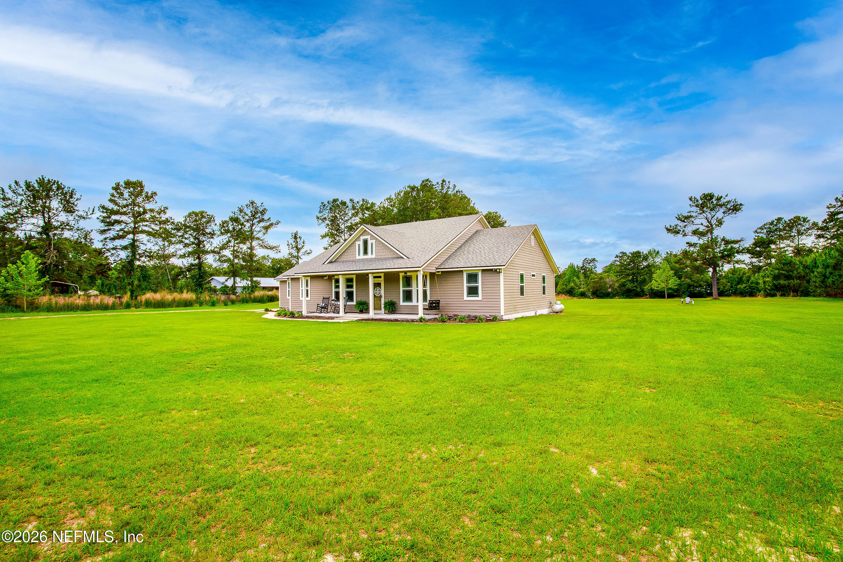 26575 Sheared Stokes Road Hilliard, FL 32046 - Photo 2 of 39 a front view of a house with garden