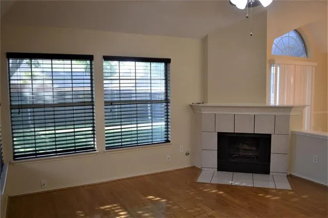 a living room with a fireplace and a large window