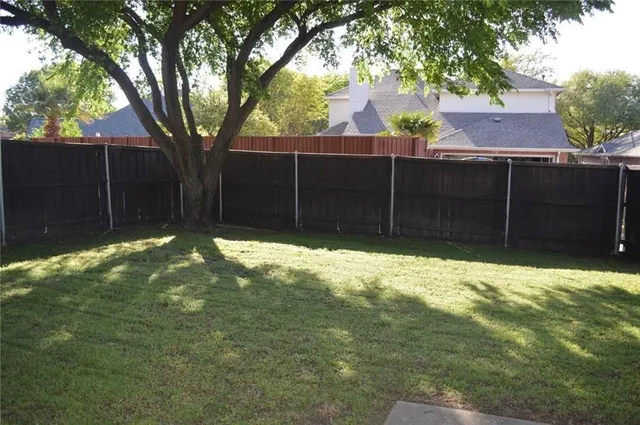 a view of a backyard of the house