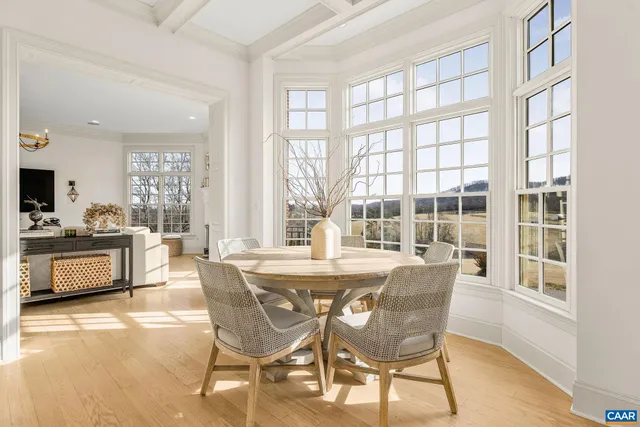 a living room with a large window and furniture