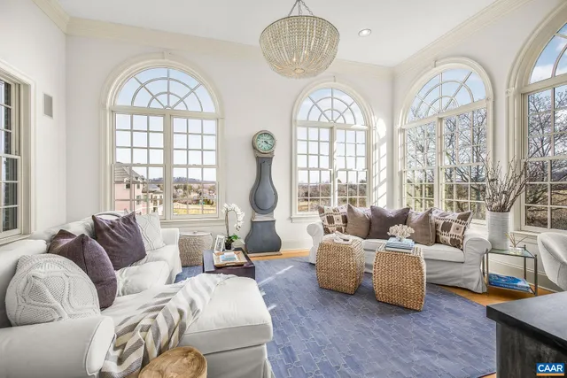 a living room with a fireplace and a large window