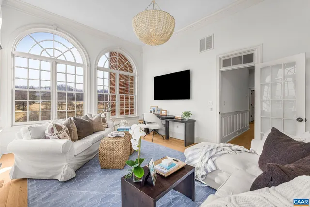 a spacious bedroom with a bed couch and a window