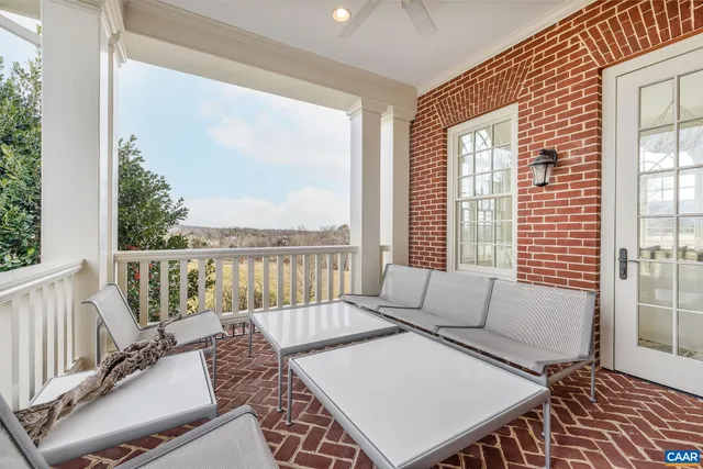 a spacious bedroom with a bed a chandelier and a window
