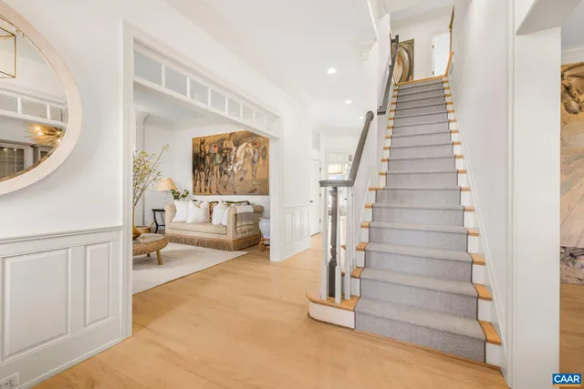 a living room with furniture a fireplace and a potted plant