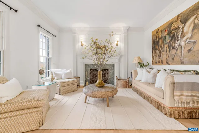 a living room with lots of furniture a dining table and chairs with wooden floor