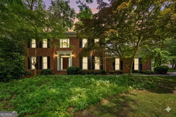a view of a brick building next to a big yard
