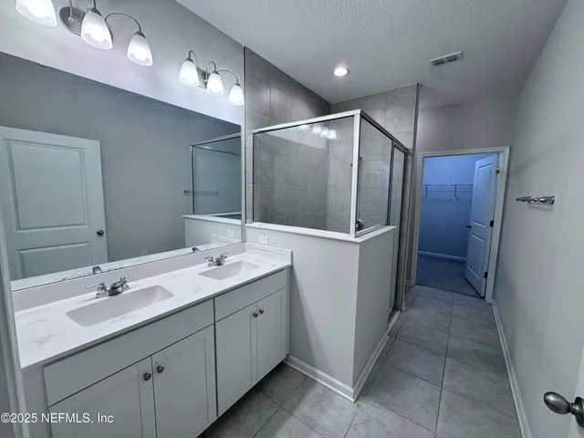 a bathroom with a double vanity sink a and a mirror
