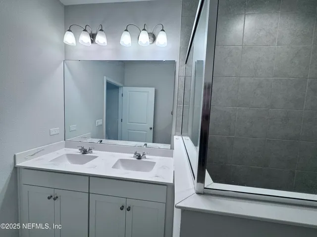 a bathroom with a sink and a mirror