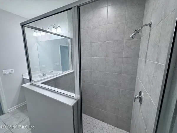 a bathroom with a bathtub and shower