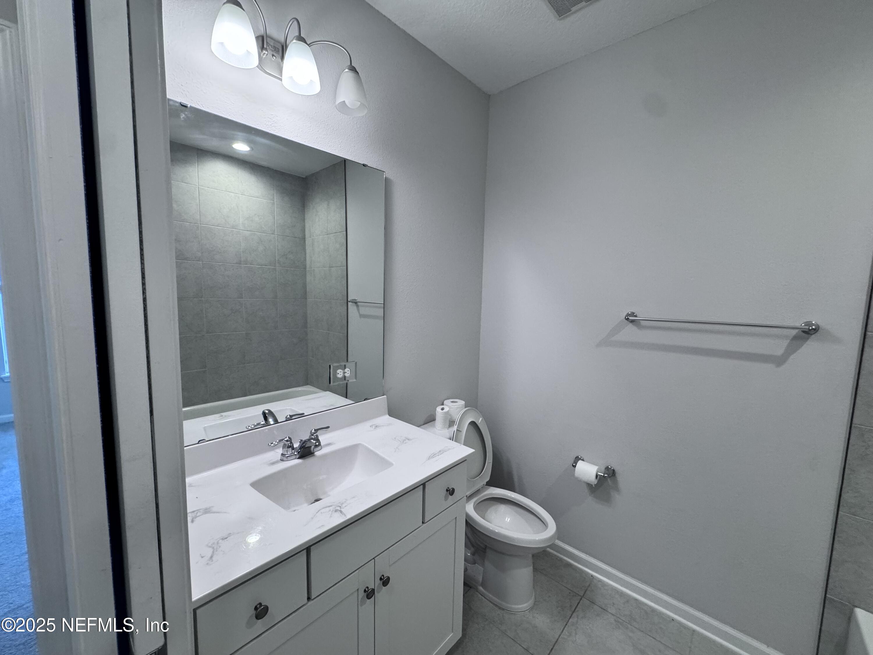 156 Charlie Way St. Augustine, FL 32095 - Photo 20 of 33 a bathroom with a sink toilet and vanity