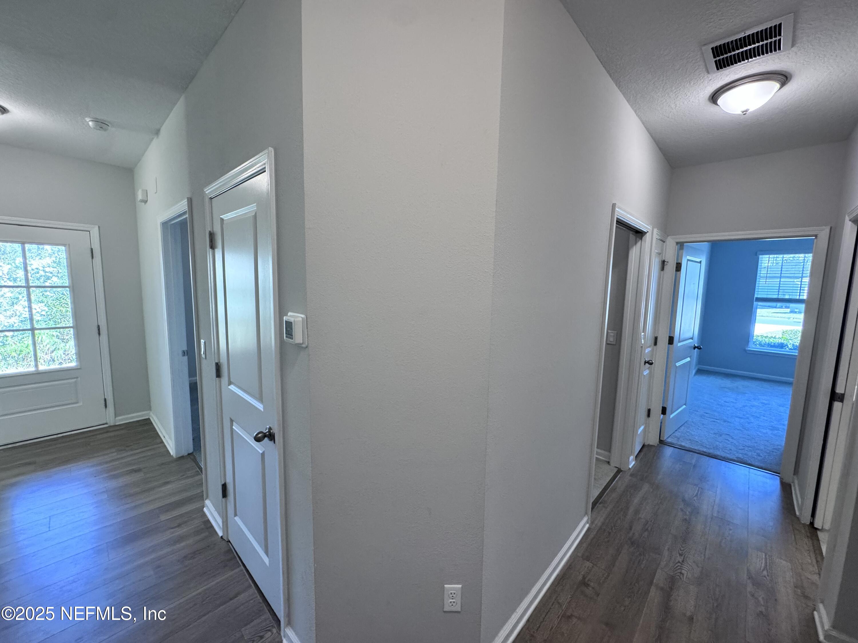 156 Charlie Way St. Augustine, FL 32095 - Photo 21 of 33 a view of a hallway with wooden floor and stairs