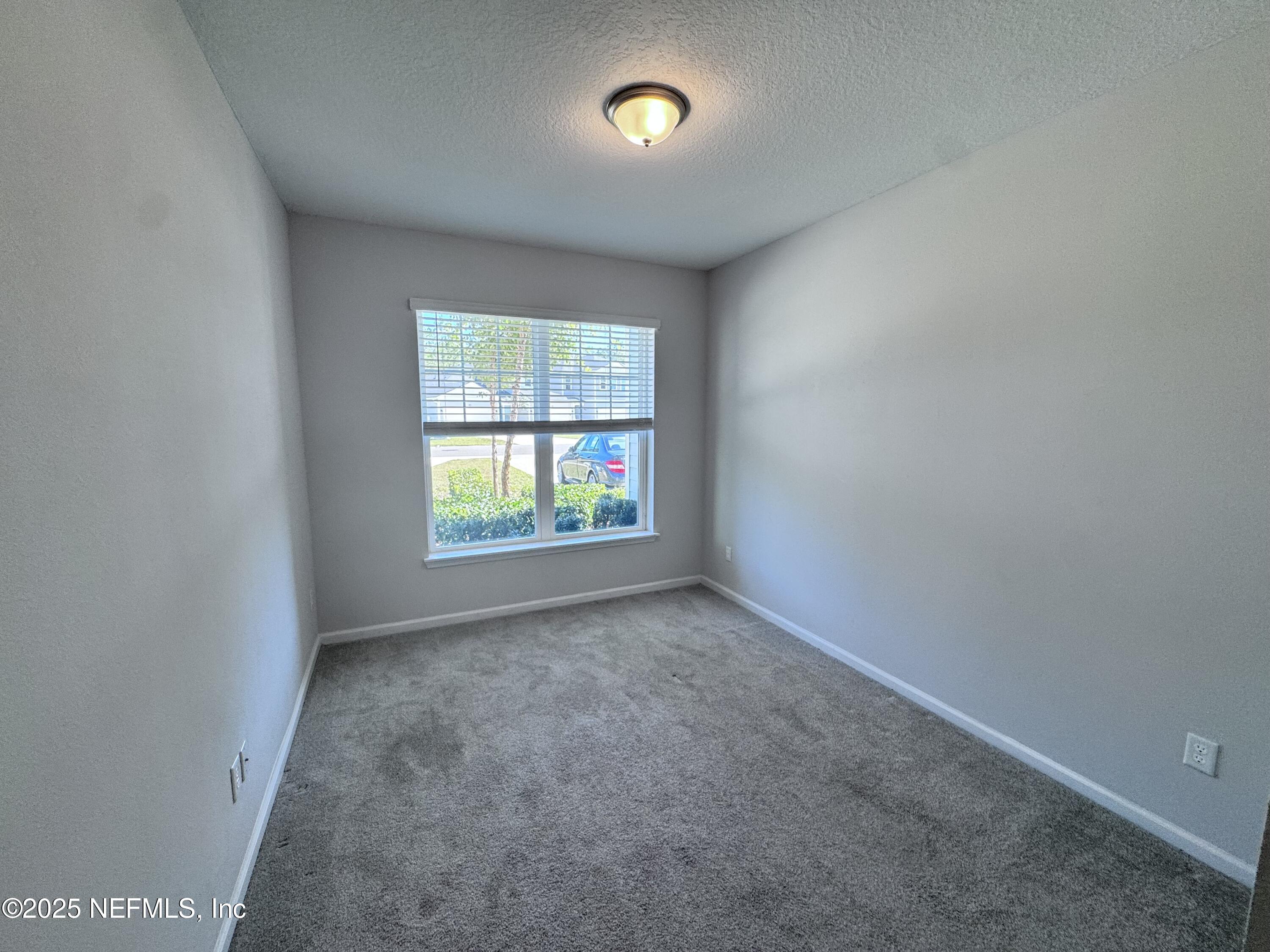 156 Charlie Way St. Augustine, FL 32095 - Photo 23 of 33 an empty room with windows