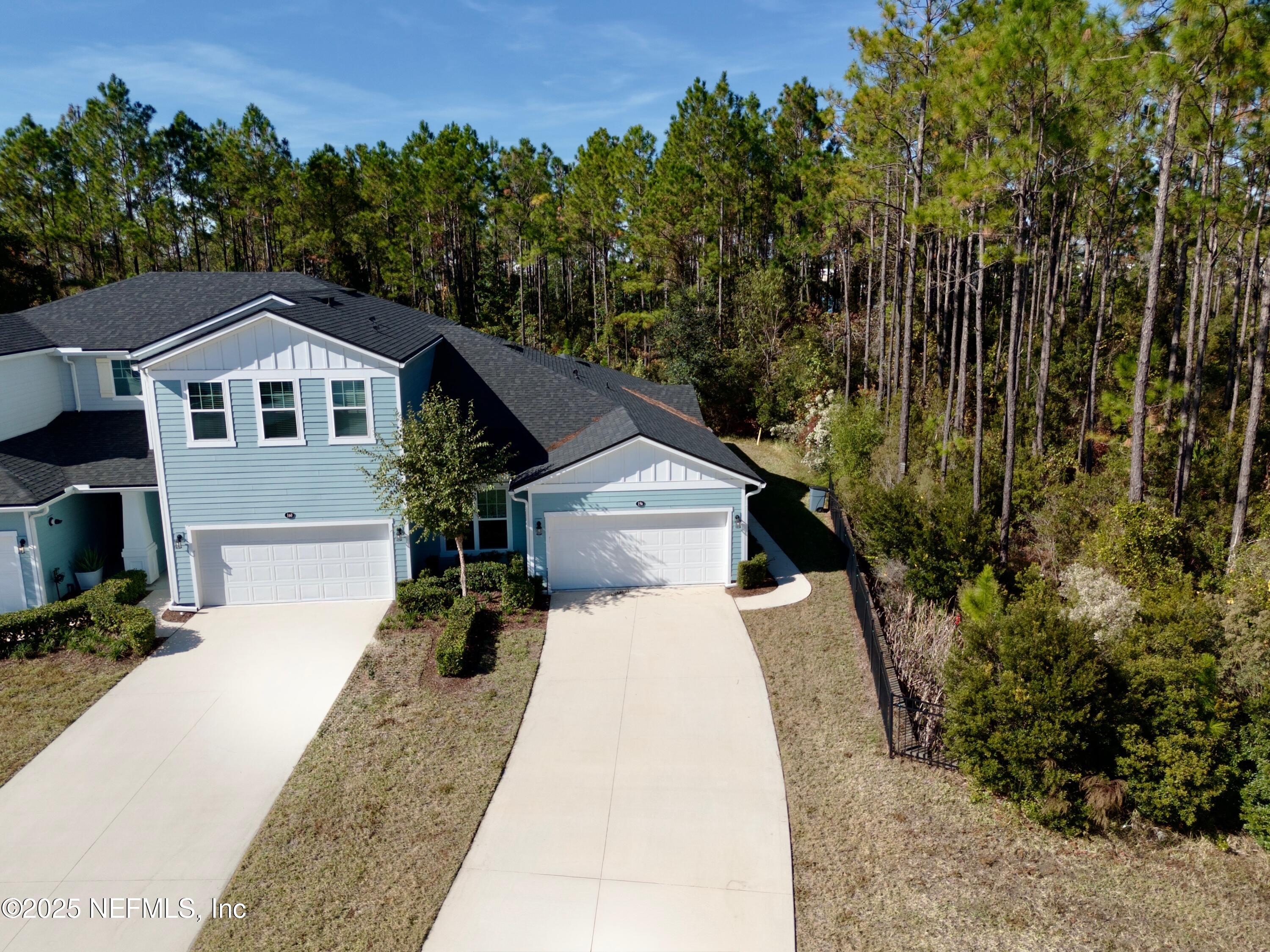 156 Charlie Way St. Augustine, FL 32095 - Photo 30 of 33 a front view of a house with a yard and trees