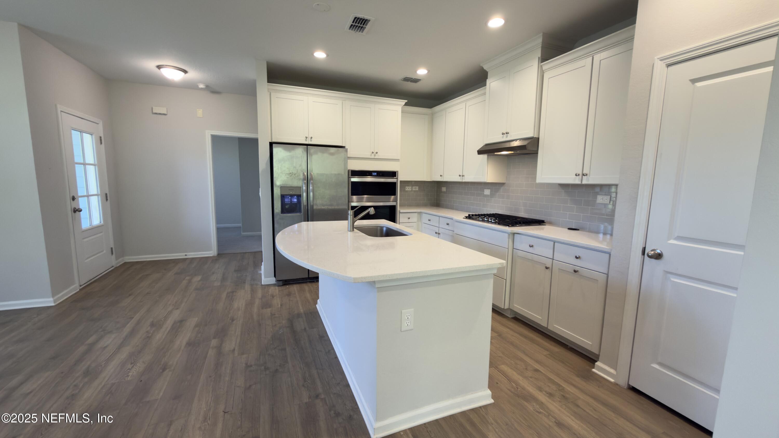156 Charlie Way St. Augustine, FL 32095 - Photo 8 of 33 a kitchen with kitchen island a sink stainless steel appliances and cabinets