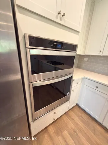 a stove top oven sitting inside of a kitchen