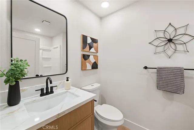 a bathroom with a sink a toilet and mirror