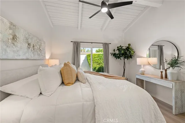 a bedroom with a bed and a potted plant