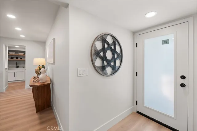 a view of a hallway with wooden floor